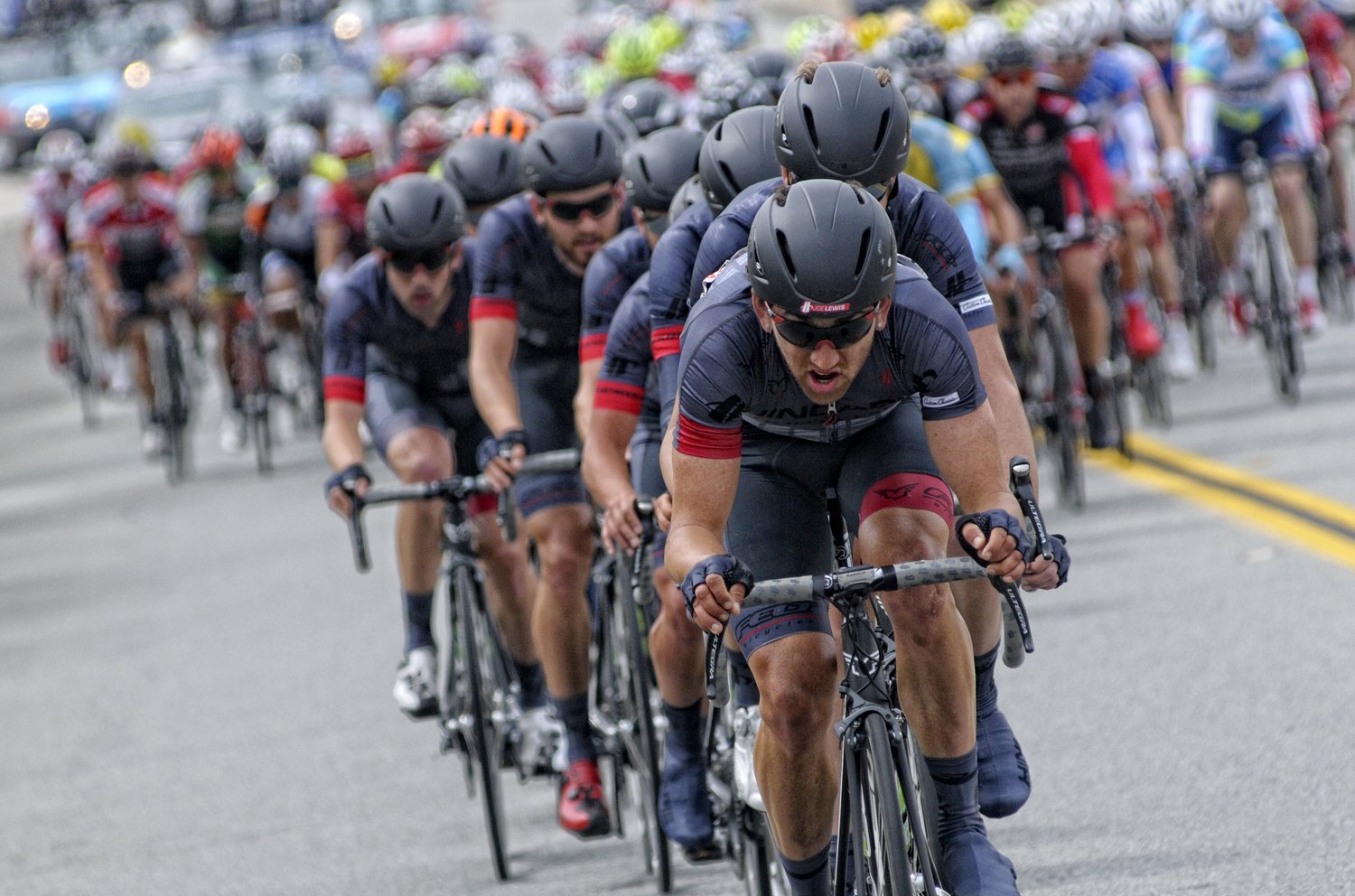 Joe Lewis cycling coach leading peloton at UCI America Tour race — First Wheel Coaching Boulder Colorado
